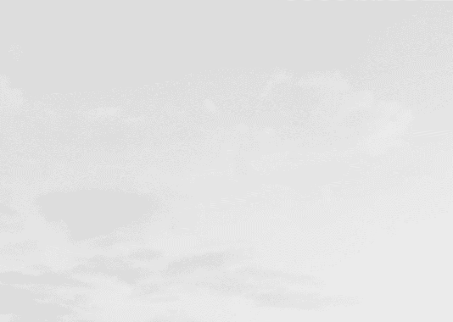 Minimalist cloudy sky background in soft gray tones, creating a clean and neutral visual space for overlaying design elements.